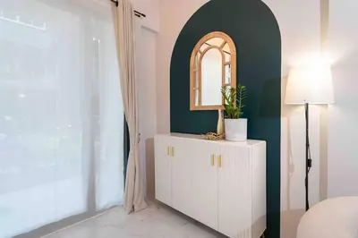 a bedroom with a white cabinet and a mirror at Private 4BR Model Home center Patong in Patong Beach
