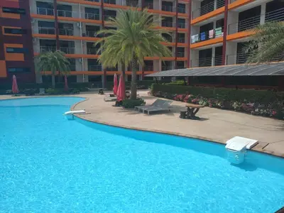 a large blue swimming pool in front of a building at Heavenly place 777 on Mai Khao in Ban Mai Salae
