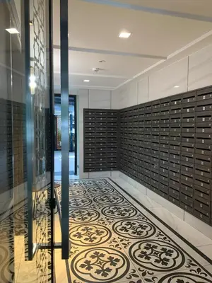 a hallway with a tile floor and a glass door at The Base Central Phuket in Phuket Town