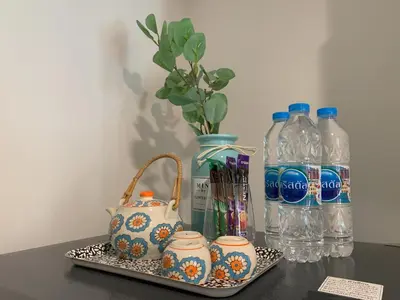 a table with a tray with a pitcher and bottles of water at The Base Central Phuket in Phuket Town