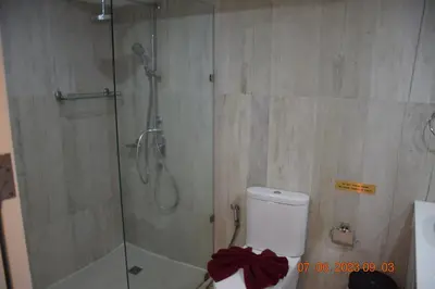 a bathroom with a shower with a toilet and a glass shower stall at KALIM RESIDENCE UNIT 133 VUE MER in Patong Beach