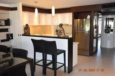 a kitchen with two statues of women sitting at a counter at KALIM RESIDENCE UNIT 133 VUE MER in Patong Beach