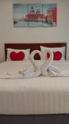 a bed with two swans made to look like hearts at Benetti house in Patong Beach