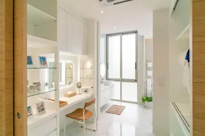a white bathroom with a sink and a mirror at The Residence by Andaman Phuket in Ban Mut Dok Khao