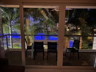 a room with a table and chairs looking out the window at Karon Butterfly Condominium Brandnew 68m2 apartment, seaview, pool access, 500m to beach in Karon Beach