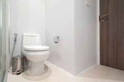a bathroom with a white toilet in a stall at Pool Access Condo Bangtao Beach in Bang Tao Beach