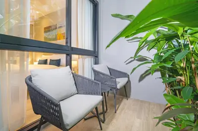 a room with two chairs and a bed at Pool Access Condo Bangtao Beach in Bang Tao Beach