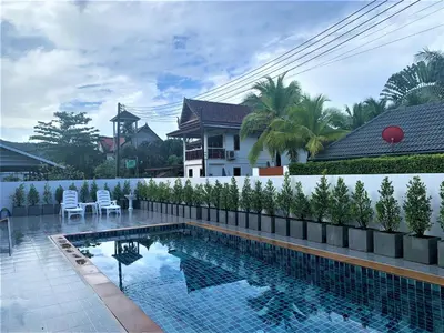 a swimming pool in front of a house at Chonlada Pool Villa - 6-BR - Kamala Beach in Phuket Town