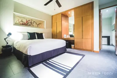 a bedroom with a large bed and a large closet at Wings Phuket Villa by Two Villas HOLIDAY in Bang Tao Beach