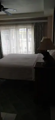 a bedroom with a white bed and a window at Rendez Vous Hotel in Patong Beach