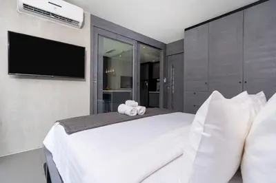 a bedroom with a bed with a teddy bear on it at Tropics Kamala Deluxe Pool View Apartment CTG P402 in Kamala Beach