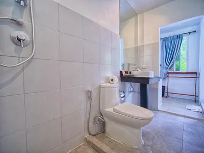 a bathroom with a toilet and a sink at Serenity Lakeside Resort in Kathu