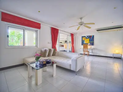 a living room with a white couch and a table at Serenity Lakeside Resort in Kathu