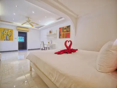 a bedroom with a bed with a red ribbon on it at Serenity Lakeside Resort in Kathu
