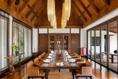 a large dining room with a long table and chairs at Villa Aye in Kamala Beach