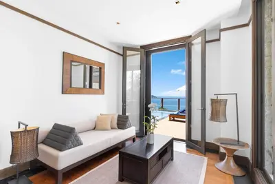 a living room with a couch and a table at Villa Aye in Kamala Beach