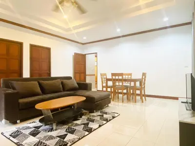 a living room with a couch and a table at Peaceful 2BR Garden Retreat Bangtao Beach A2 in Ban Thalat Choeng Thale