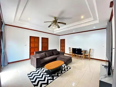 a living room with a couch and a table at Peaceful 2BR Garden Retreat Bangtao Beach A2 in Ban Thalat Choeng Thale
