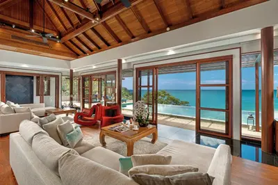 an open living room with a view of the ocean at Villa Varya in Amphoe Thalang