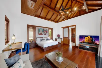 a bedroom with a bed and a living room at Villa Varya in Amphoe Thalang