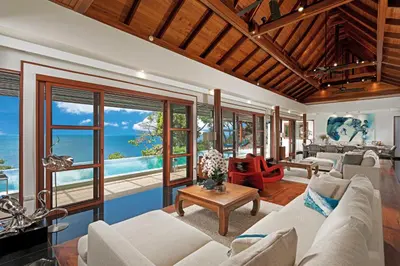 a living room with a couch and a table at Villa Varya in Amphoe Thalang