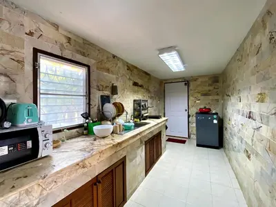 a kitchen with stone walls and a counter top at 2BR Private Villa Natural Stone Style A3 in Ban Thalat Choeng Thale