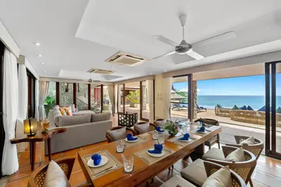 a living room with a table and a couch at Villa Horizon in Phuket Town