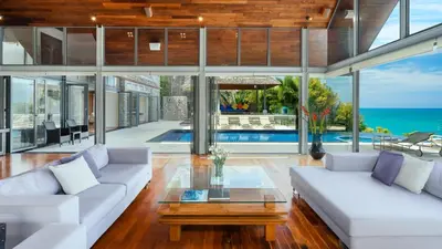 a living room with white couches and a table at Villa Viman in Kathu