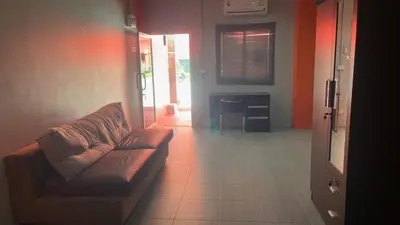 a living room with a couch and a table at KARON STUDIO APARTMENT in Karon Beach
