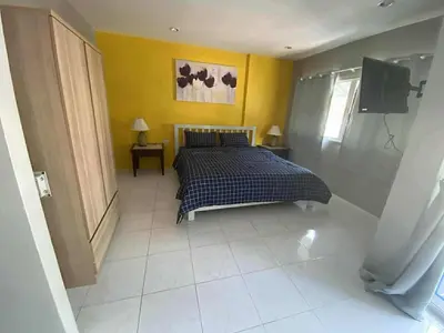 a bedroom with a bed and a tv in it at KARON STUDIO APARTMENT in Karon Beach