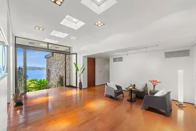 a living room with a table and chairs and a large window at Villa Hale Malia in Kathu