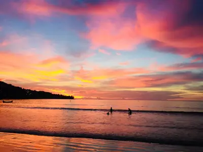two people walking in the water at the beach at sunset at Recommend a warm Thai style private swimming pool villa with convenient traffic and living, walking 700 meters to the the beach in Kamala Beach