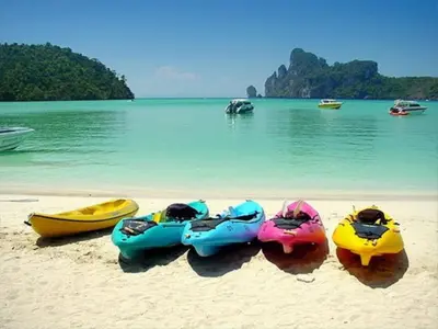 a group of three kayaks on a beach at Coco Bella Hotel in Phi Phi Don