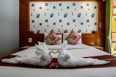 a bed with two swans made out of towels at Coco Bella Hotel in Phi Phi Don