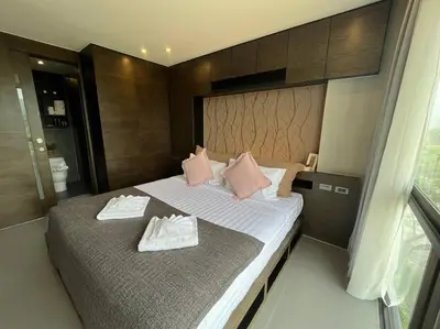 a bedroom with two beds with towels on them at Citygate in Kamala beach - Perfect Stay for Digital Work in Kamala Beach