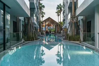 a swimming pool in the middle of a building at Modern Condo Palmyrah by Lofty in Surin Beach
