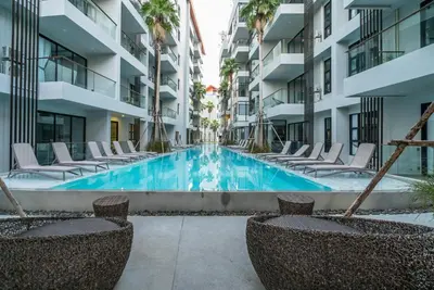a swimming pool in the middle of a apartment building at Modern Condo Palmyrah by Lofty in Surin Beach
