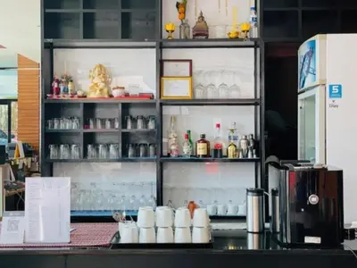 a display case in a coffee shop with drinks at Coco boutique hotel in Patong Beach