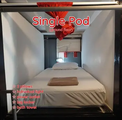 a magazine cover of a single pod with a bed at Dormsin Chill in Phi Phi Don