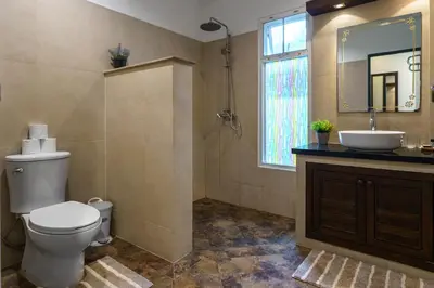 a bathroom with a toilet and a sink and a mirror at Meursault Villa by G Estate in Rawai Beach