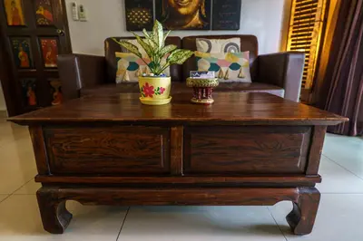 a wooden coffee table with a potted plant on top at Meursault Villa by G Estate in Rawai Beach