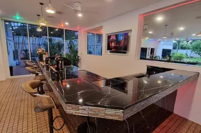 a bar with a glass counter top in a room at Baan Paa Phuket - 6 Bedrooms Villa in Rawai Beach