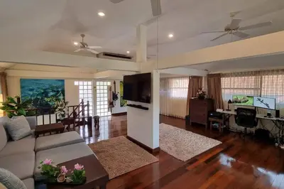 a living room with a couch and a table at Baan Paa Phuket - 6 Bedrooms Villa in Rawai Beach
