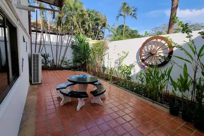 a patio with a table on a brick patio at Baan Paa Phuket - 6 Bedrooms Villa in Rawai Beach