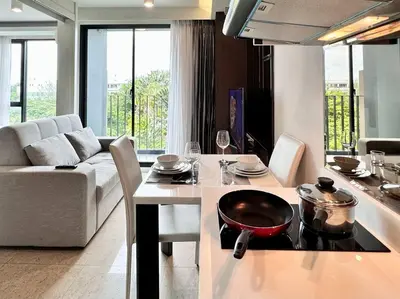 a kitchen and living room with a table and a stove at Aristo Resort Surin Beach M47 in Phuket Town