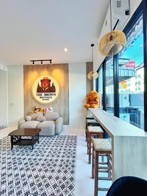 a living room with a couch and a table at The Brown Boutique Patong in Patong Beach