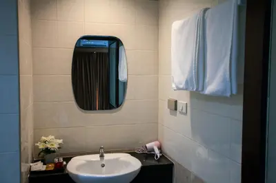 a bathroom with a sink and a mirror at The Brown Boutique Patong in Patong Beach
