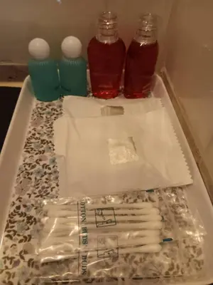 a table with two bottles and a tray with drinks at The Brown Boutique Patong in Patong Beach