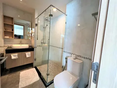 a bathroom with a shower and a toilet and a sink at 1 bed Corner apartment in Kata - Grand Kata VIP in Kata Beach