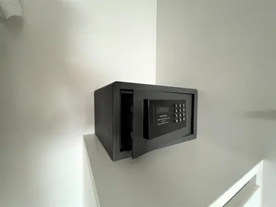 a microwave oven on a white wall at 1 bed Corner apartment in Kata - Grand Kata VIP in Kata Beach